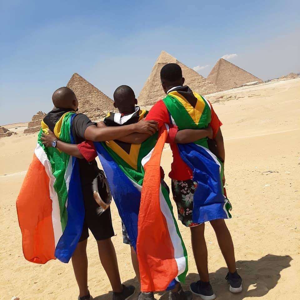 African fans look to the pyramids giving their back to the camera
