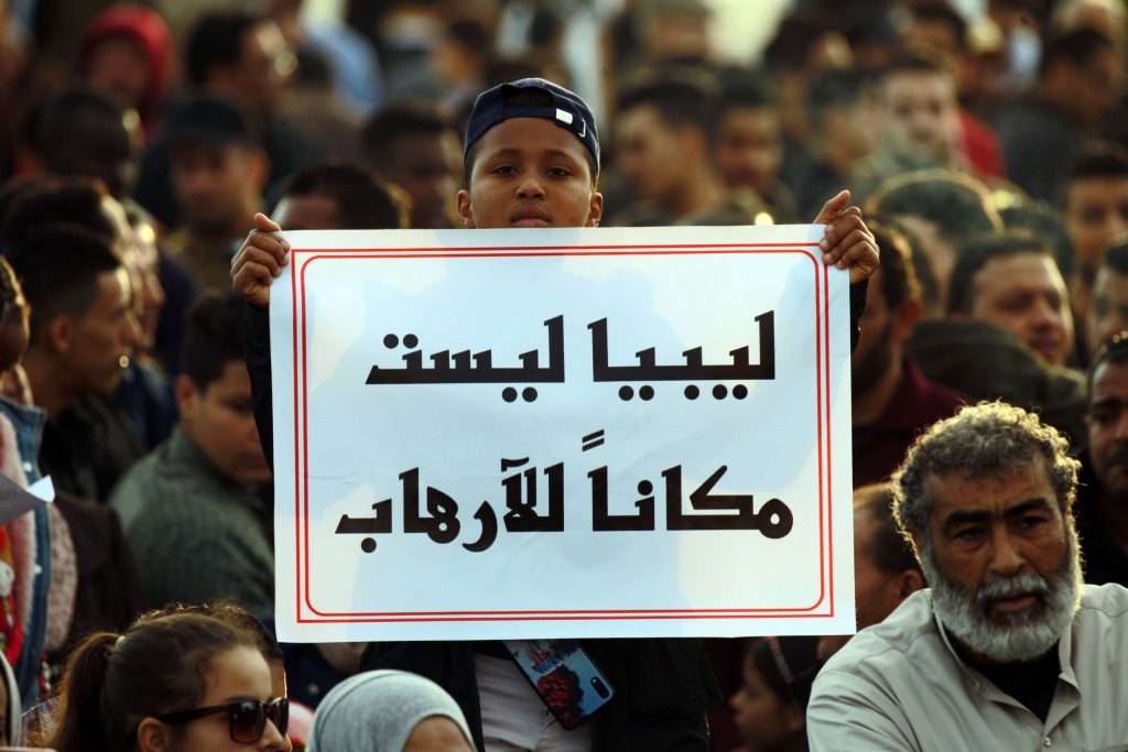 Turkey Libyan Libya boy carries a sign reading Libya is not a place for terrorism'