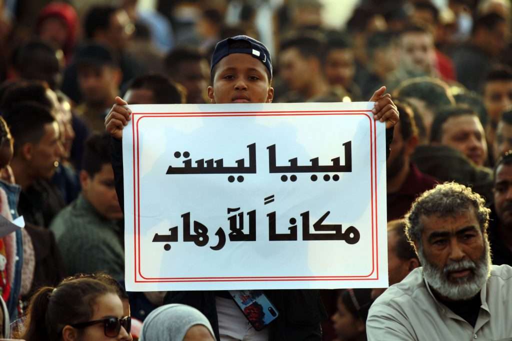 Libyan Libya boy carries a sign reading Libya is not a place for terrorism'